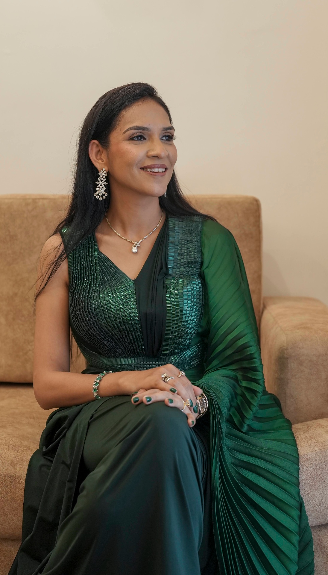 Riddhi seated wearing a green saree