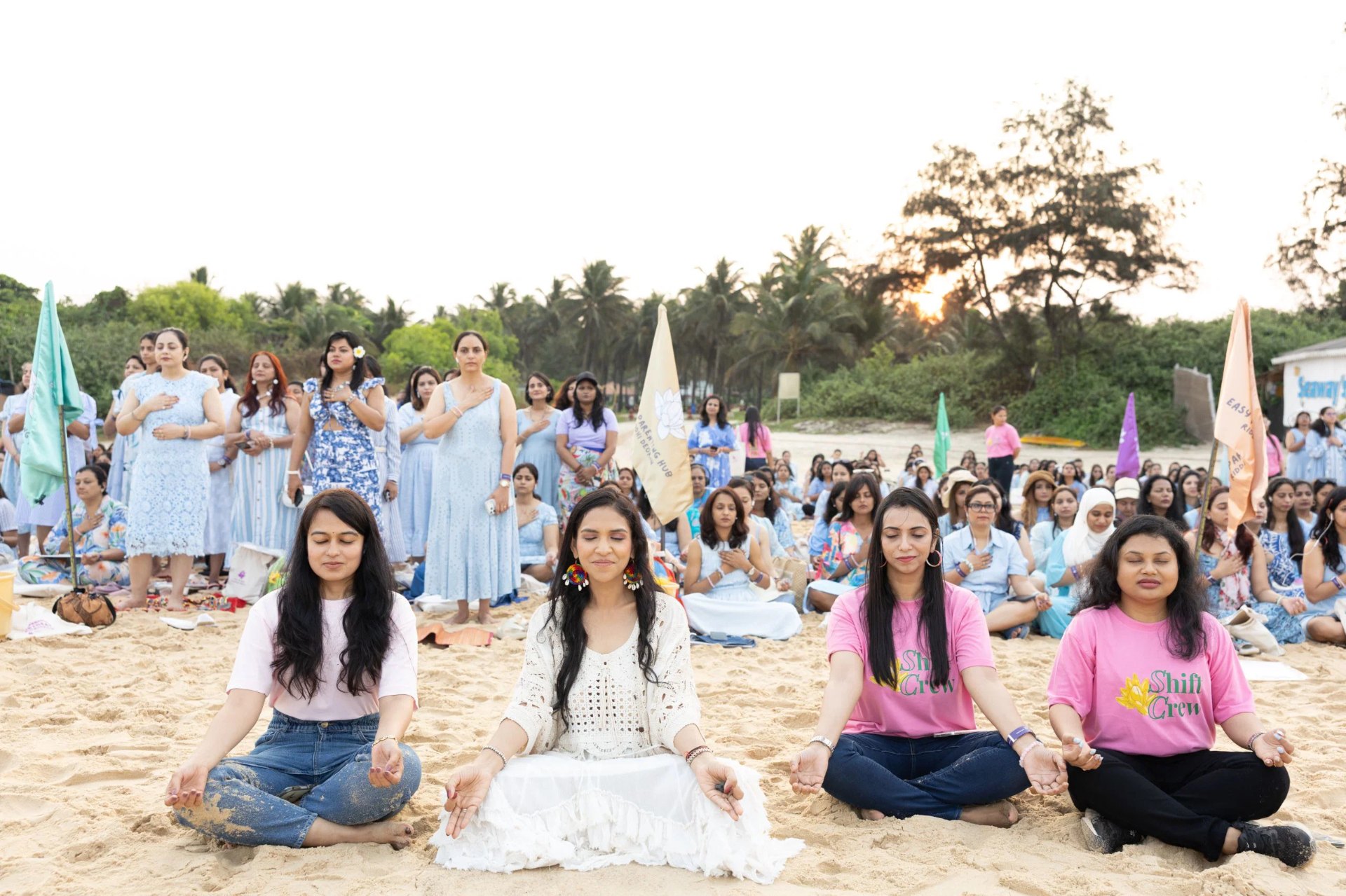 Riddhi on stage at the Supermom Retreat with mothers cheering